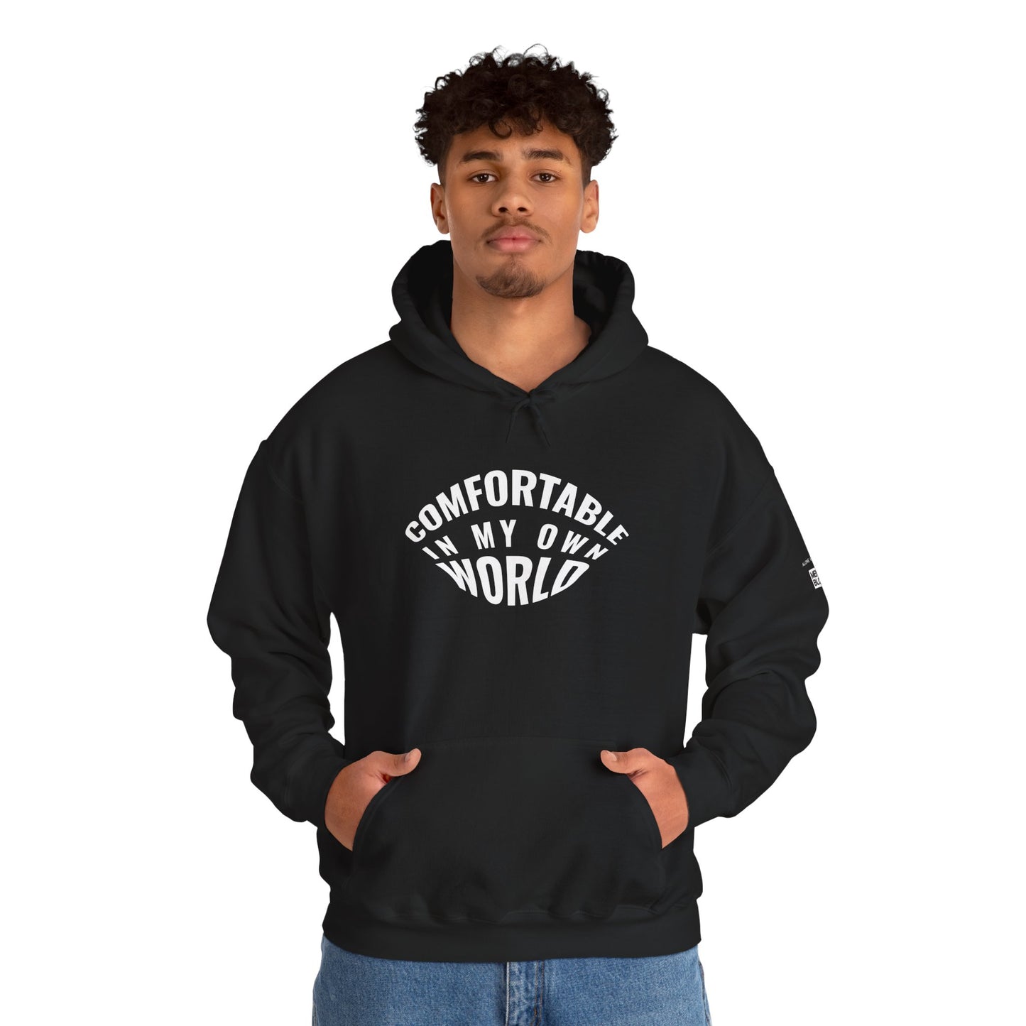 Person wearing a black hoodie with 'Comfortable in My Own World' text on a white background