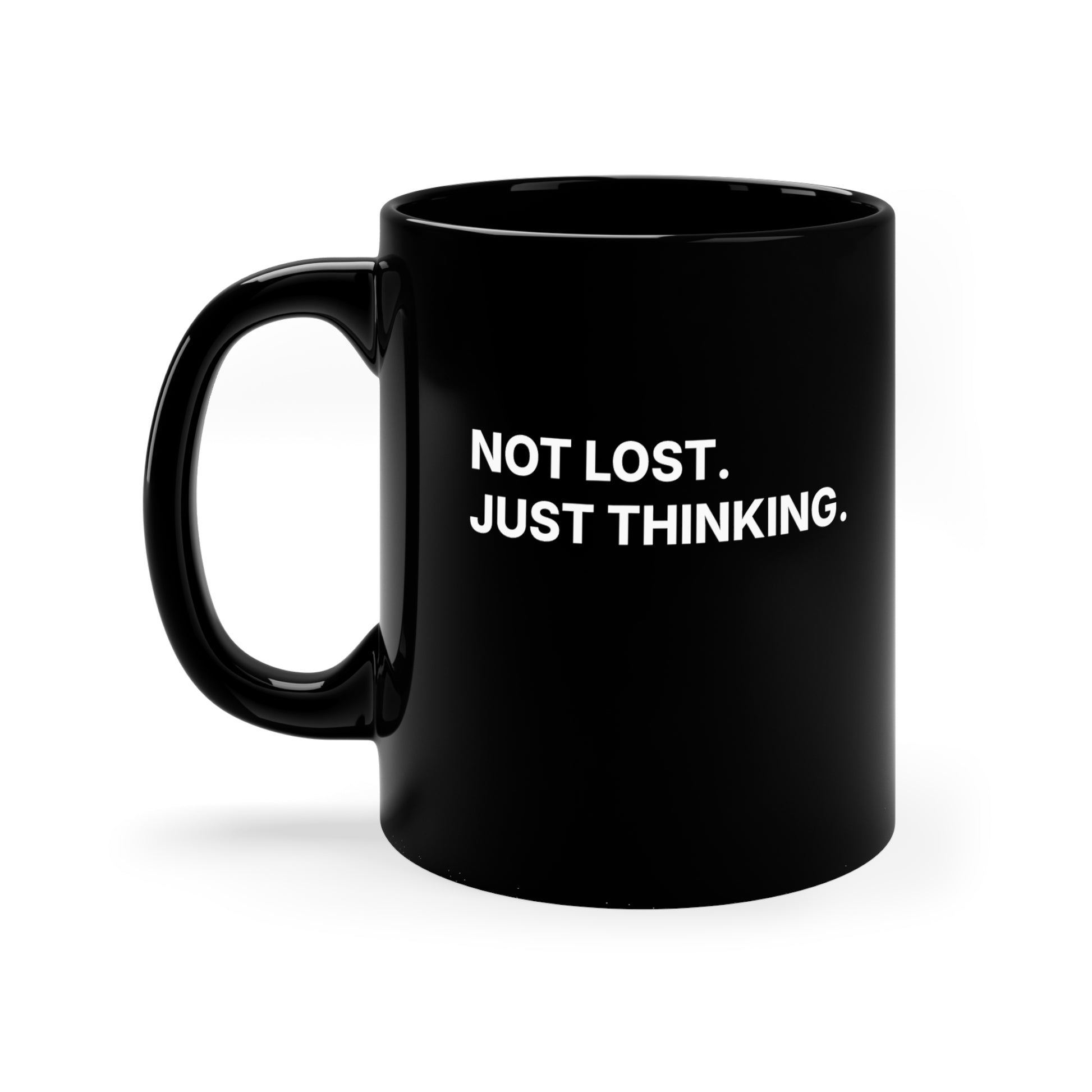 Black mug with 'NOT LOST. JUST THINKING.' text on a white background