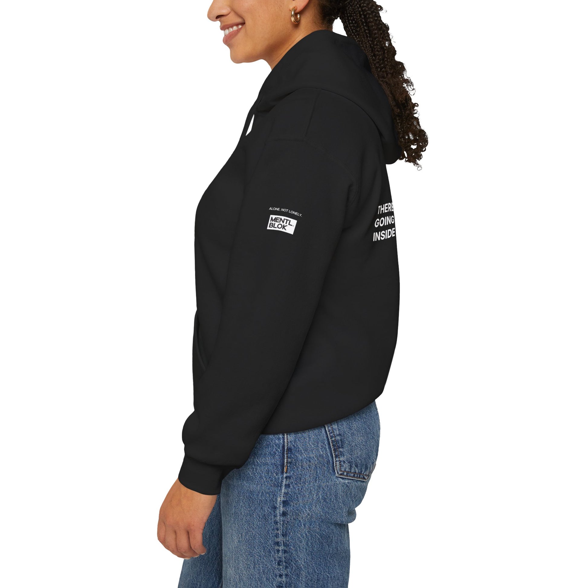 Person wearing a black hoodie with text on the sleeve against a white background