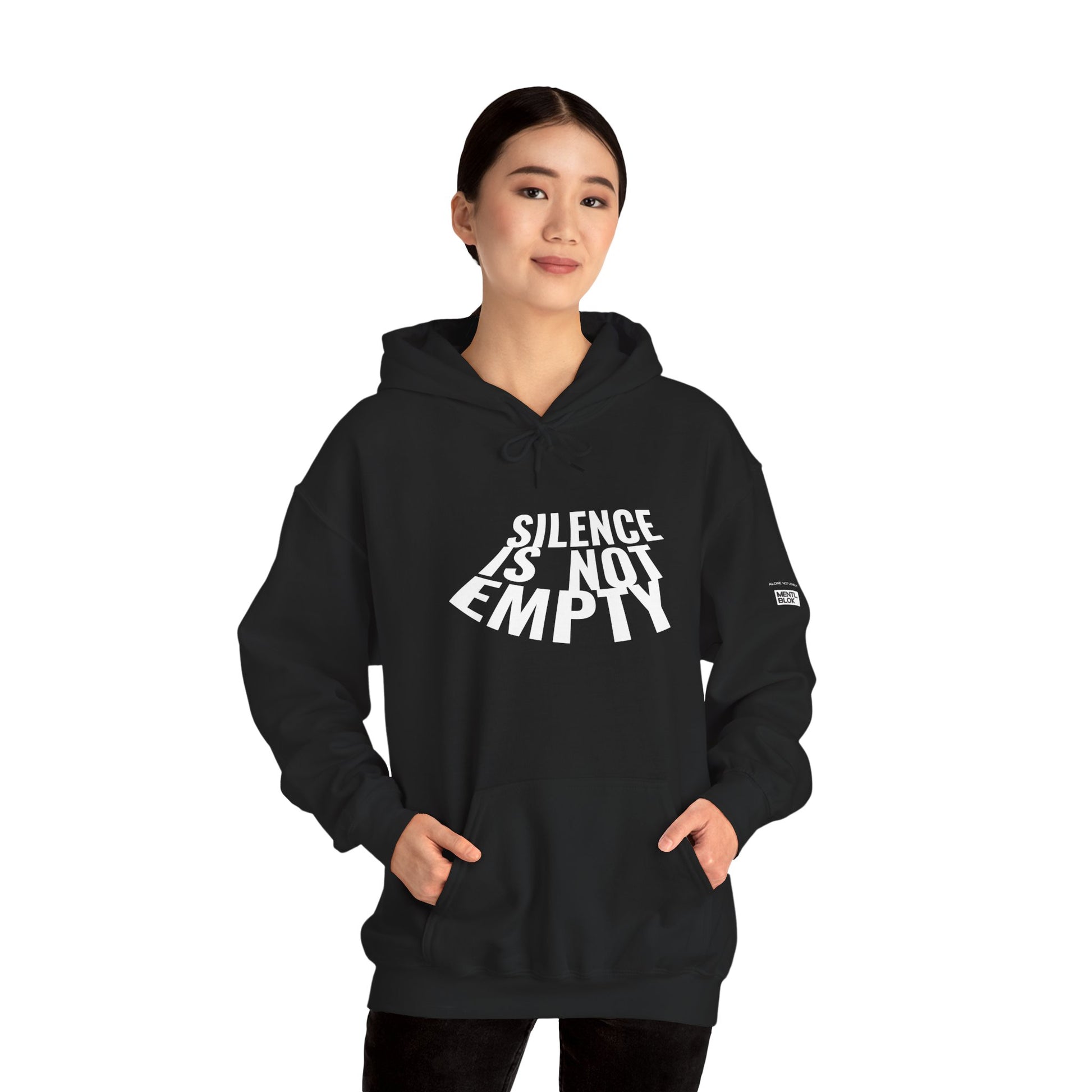 Person wearing a black hoodie with 'Silence is Not Empty' text on a white background
